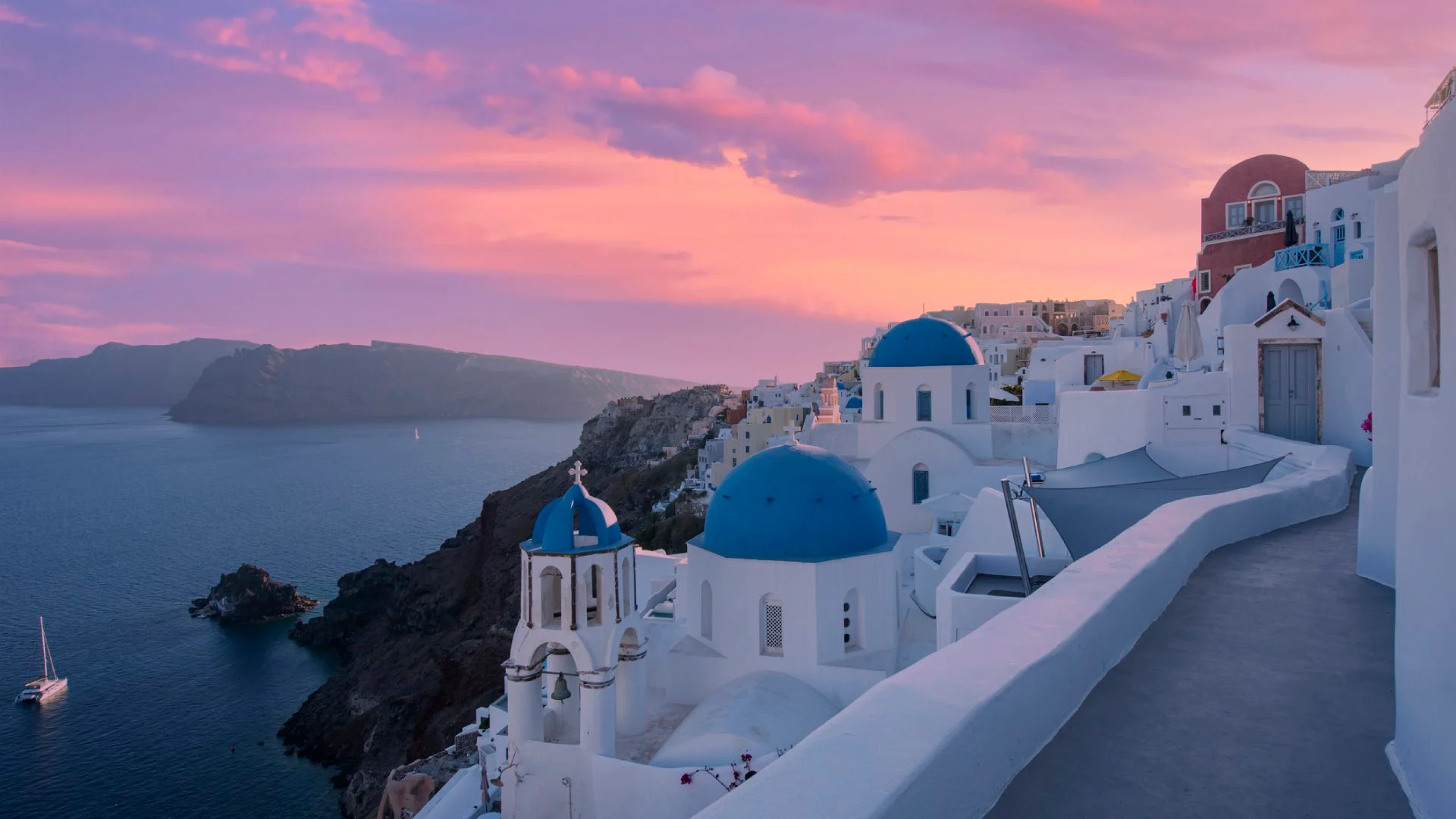 Small-Village-of-Oia-at-sunset,-located-on-Greek-island-of-Santorini,-Greece__iStock-1324871336.jpg